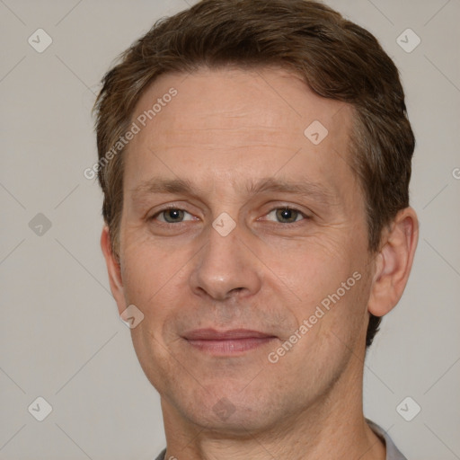 Joyful white adult male with short  brown hair and grey eyes