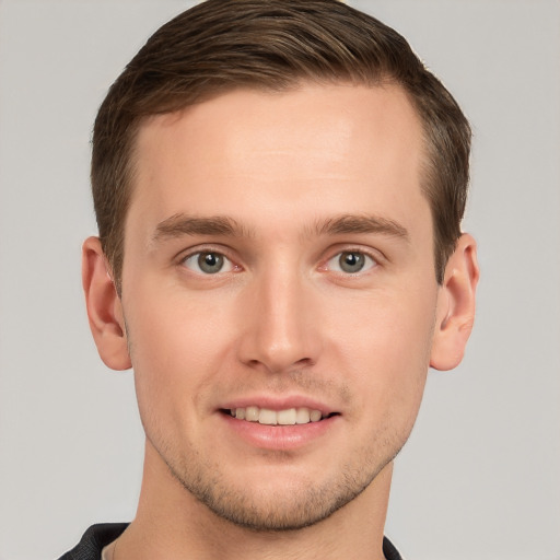 Joyful white young-adult male with short  brown hair and grey eyes