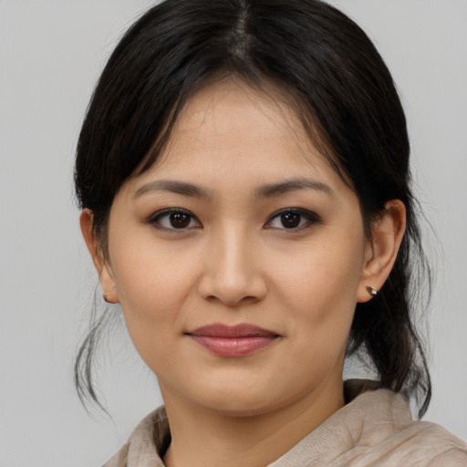 Joyful asian young-adult female with medium  brown hair and brown eyes