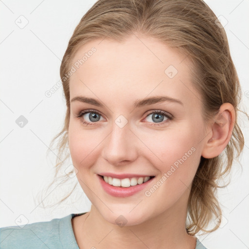 Joyful white young-adult female with medium  brown hair and blue eyes