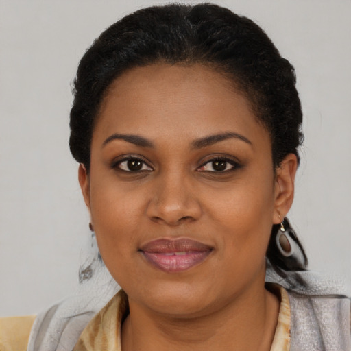 Joyful black young-adult female with short  brown hair and brown eyes