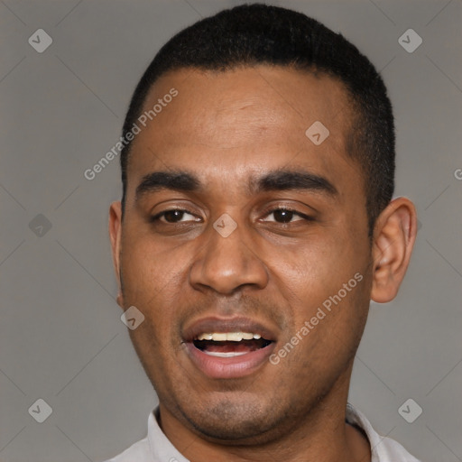 Joyful black young-adult male with short  black hair and brown eyes
