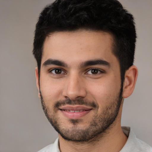 Joyful white young-adult male with short  black hair and brown eyes