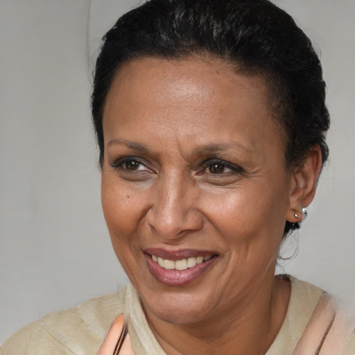 Joyful latino adult female with short  brown hair and brown eyes