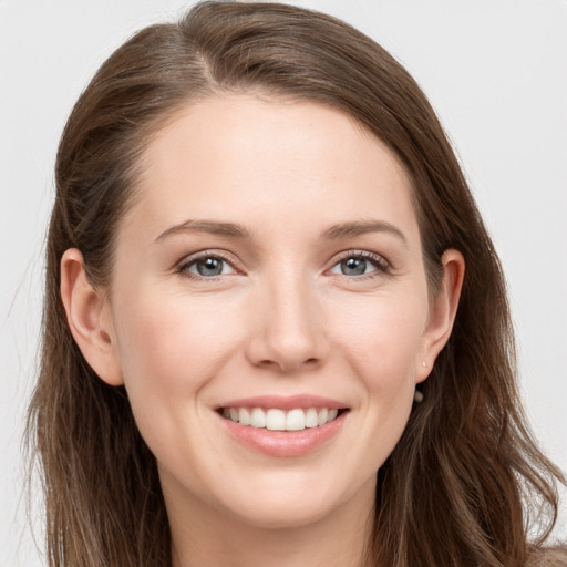 Joyful white young-adult female with long  brown hair and grey eyes