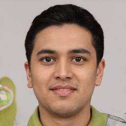 Joyful latino young-adult male with short  black hair and brown eyes