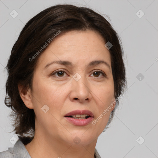 Joyful white adult female with medium  brown hair and brown eyes