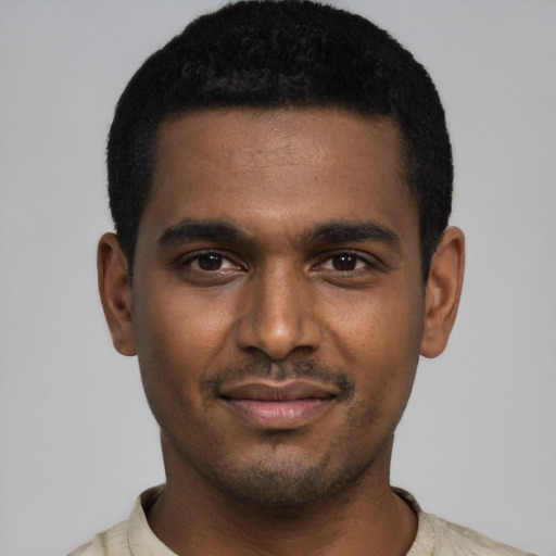Joyful black young-adult male with short  black hair and brown eyes