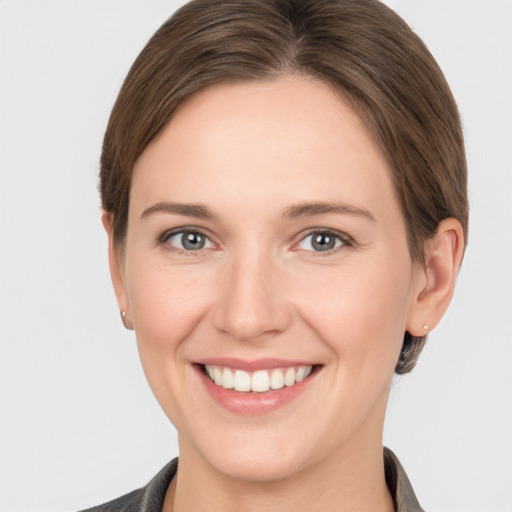 Joyful white young-adult female with short  brown hair and grey eyes