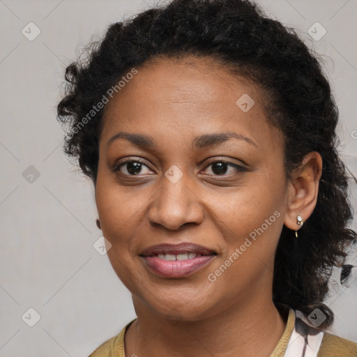 Joyful black adult female with medium  brown hair and brown eyes