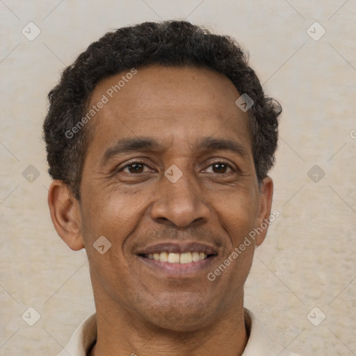 Joyful black adult male with short  brown hair and brown eyes