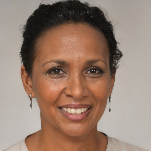Joyful black adult female with short  brown hair and brown eyes