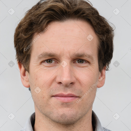 Joyful white adult male with short  brown hair and grey eyes