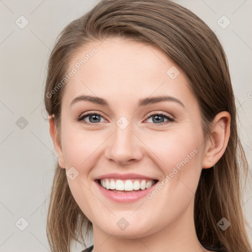 Joyful white young-adult female with medium  brown hair and blue eyes