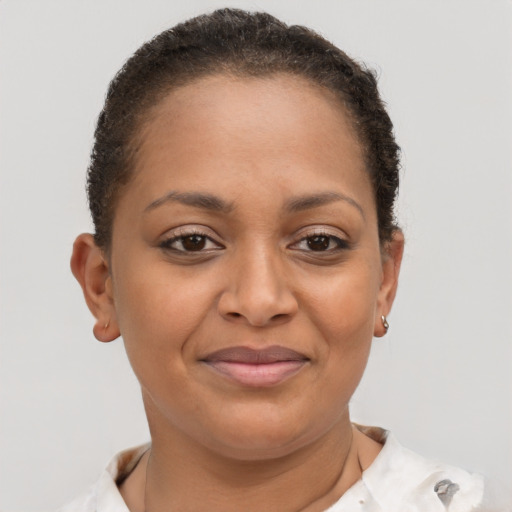 Joyful black young-adult female with short  brown hair and brown eyes