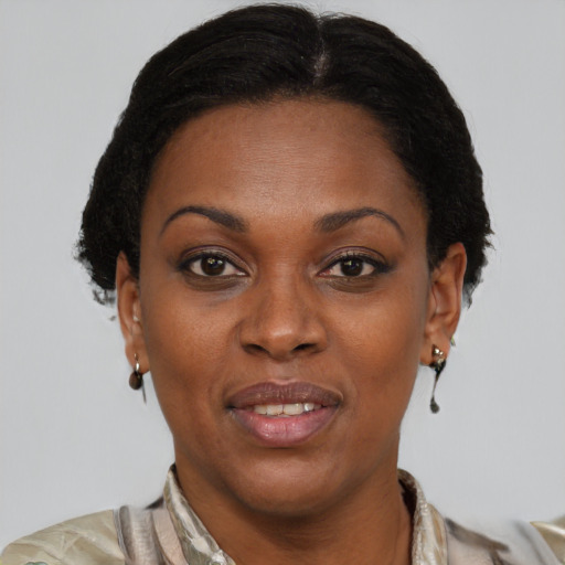 Joyful black adult female with short  brown hair and brown eyes