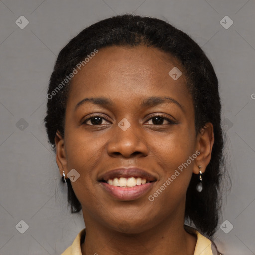 Joyful black young-adult female with long  black hair and brown eyes