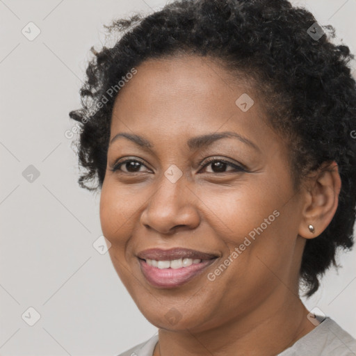 Joyful black adult female with short  brown hair and brown eyes