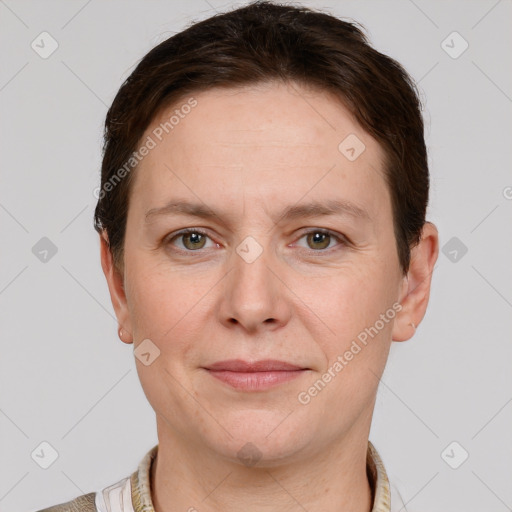 Joyful white adult female with short  brown hair and grey eyes