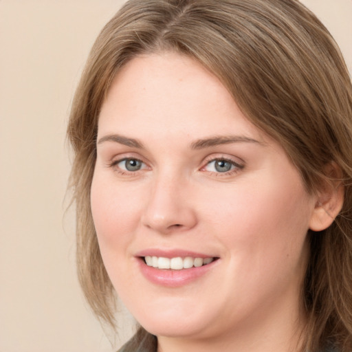 Joyful white young-adult female with long  brown hair and grey eyes