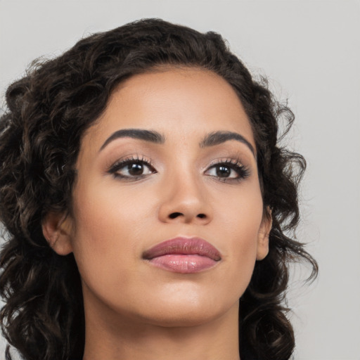 Joyful latino young-adult female with long  brown hair and brown eyes