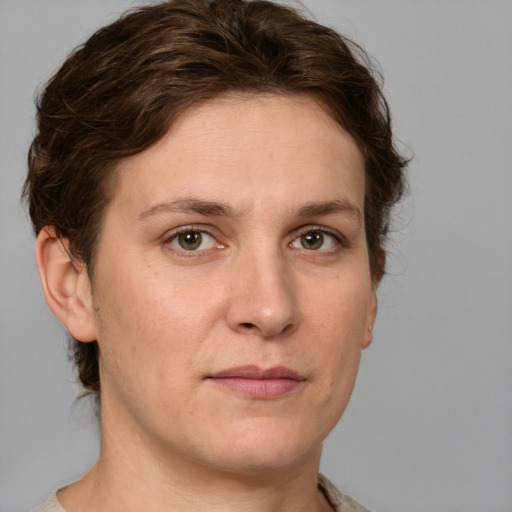 Joyful white adult female with medium  brown hair and grey eyes