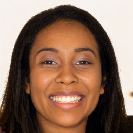 Joyful black young-adult female with long  brown hair and brown eyes