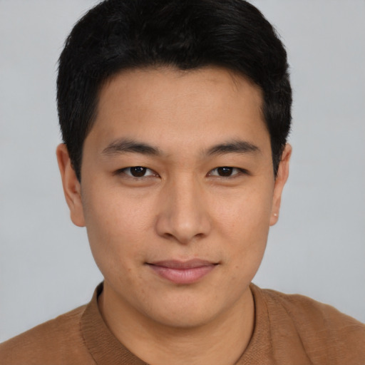 Joyful asian young-adult male with short  brown hair and brown eyes