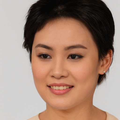 Joyful asian young-adult female with medium  brown hair and brown eyes
