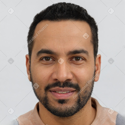 Joyful latino young-adult male with short  black hair and brown eyes