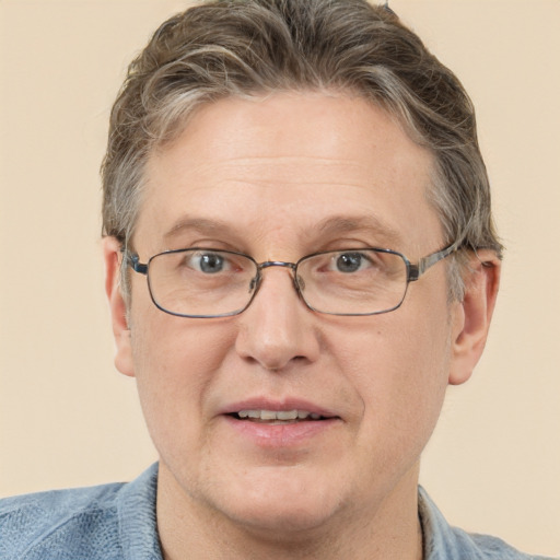 Joyful white adult male with short  brown hair and blue eyes