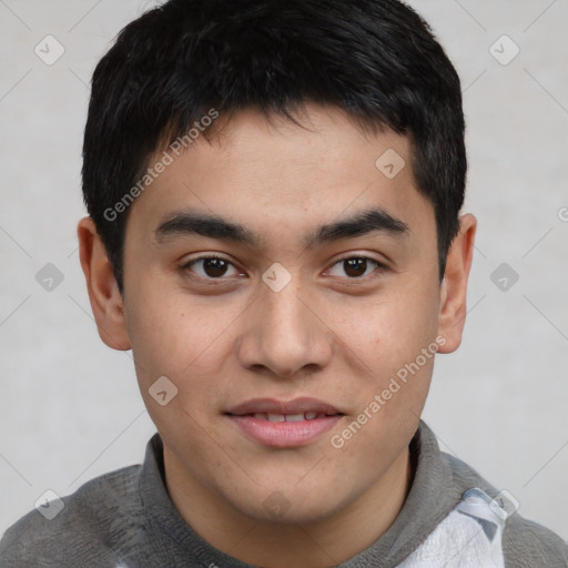 Joyful asian young-adult male with short  brown hair and brown eyes