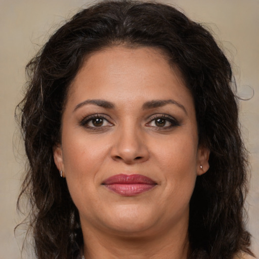 Joyful white adult female with long  brown hair and brown eyes