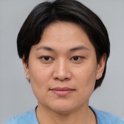 Joyful asian adult female with short  brown hair and brown eyes