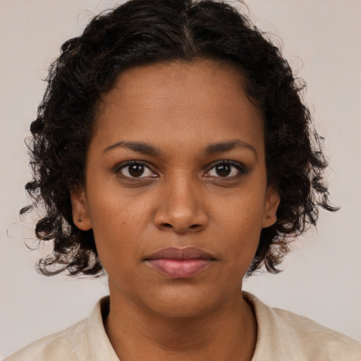 Neutral black young-adult female with medium  brown hair and brown eyes