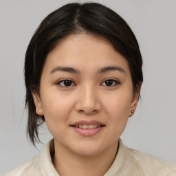 Joyful asian young-adult female with medium  brown hair and brown eyes