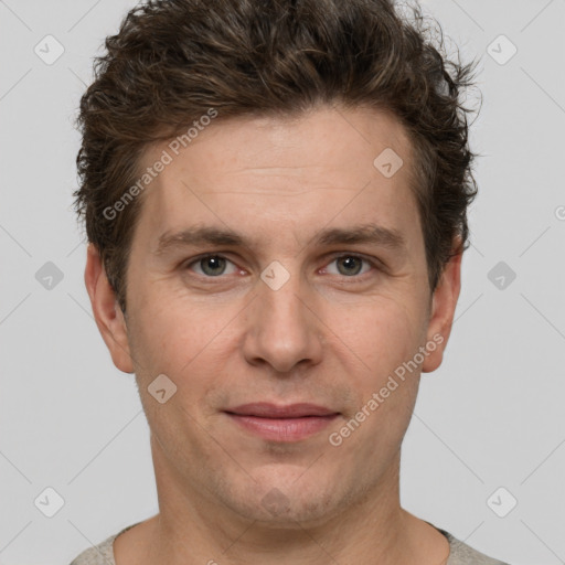 Joyful white adult male with short  brown hair and grey eyes