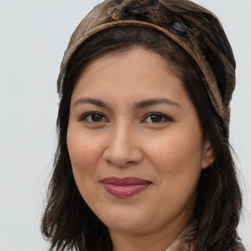 Joyful latino young-adult female with long  brown hair and brown eyes