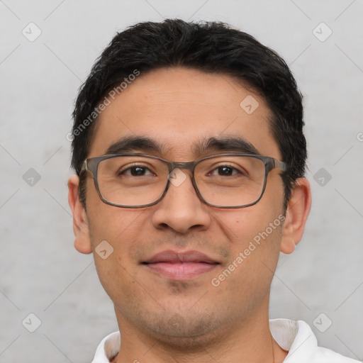 Joyful white young-adult male with short  black hair and brown eyes