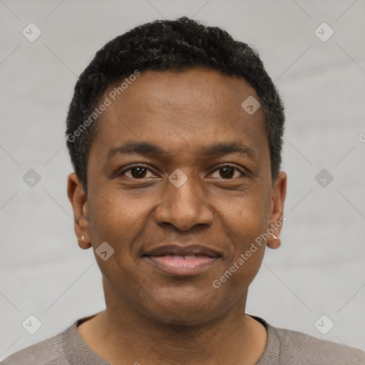 Joyful latino young-adult male with short  brown hair and brown eyes