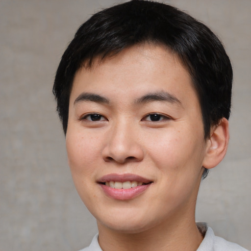 Joyful asian young-adult male with short  brown hair and brown eyes
