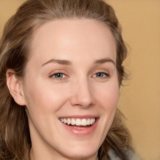 Joyful white young-adult female with long  brown hair and grey eyes