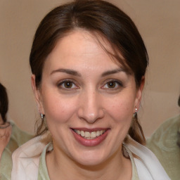 Joyful white adult female with medium  brown hair and brown eyes