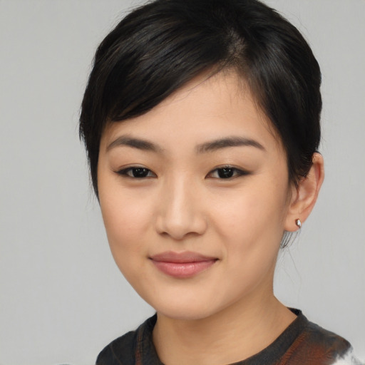 Joyful asian young-adult female with medium  black hair and brown eyes