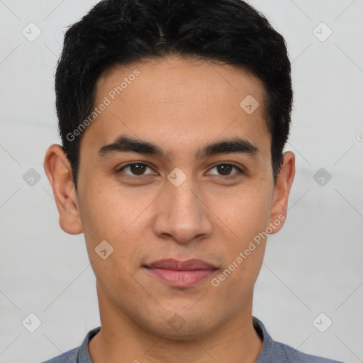 Joyful latino young-adult male with short  brown hair and brown eyes