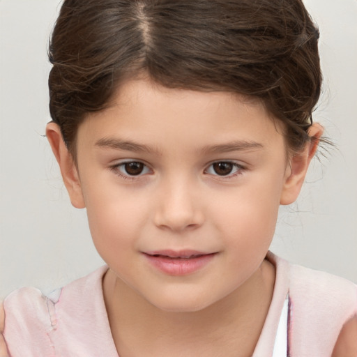 Joyful white child female with short  brown hair and brown eyes