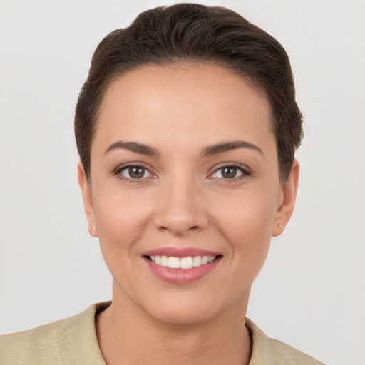 Joyful white young-adult female with short  brown hair and brown eyes