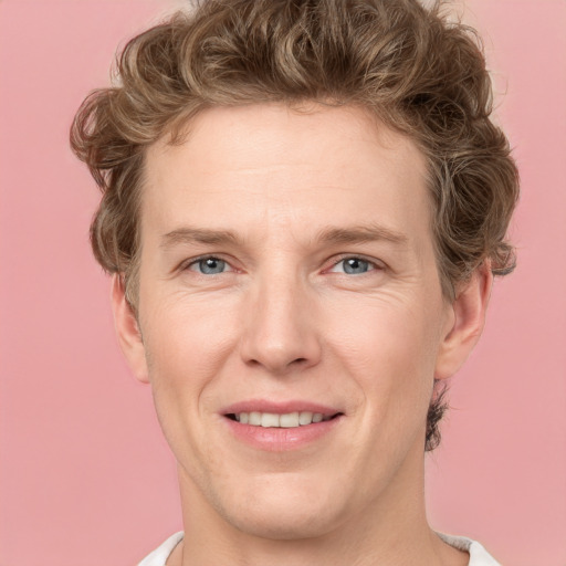 Joyful white adult male with short  brown hair and grey eyes