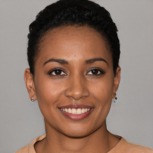 Joyful latino young-adult female with short  black hair and brown eyes