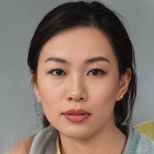 Neutral asian young-adult female with medium  brown hair and brown eyes